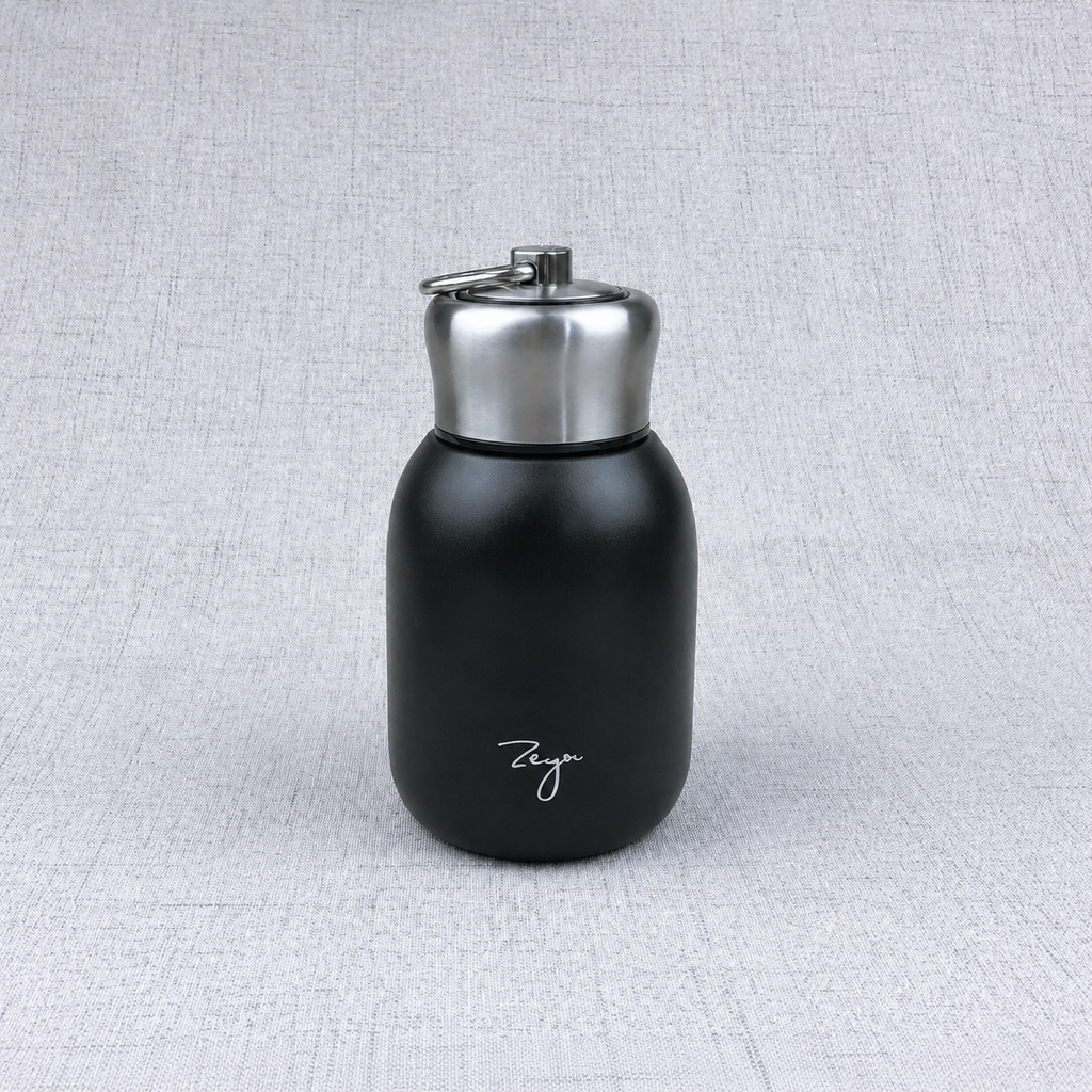 Compact insulated bottle in black, with stainless-steel lid and metal carrying loop.