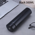 Black 500 ml insulated bottle with a digital lid displaying 58°C, shown beside a laptop and glasses.