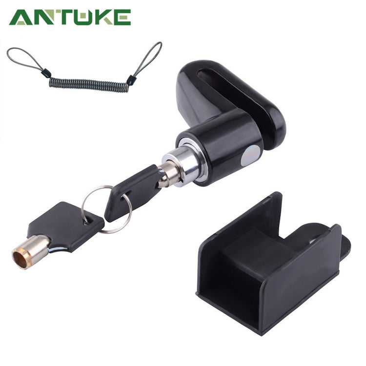 Black magnetic door stopper with a key and keychain, shown alongside its mounting bracket on a white background with the ANTUKÉ brand logo.