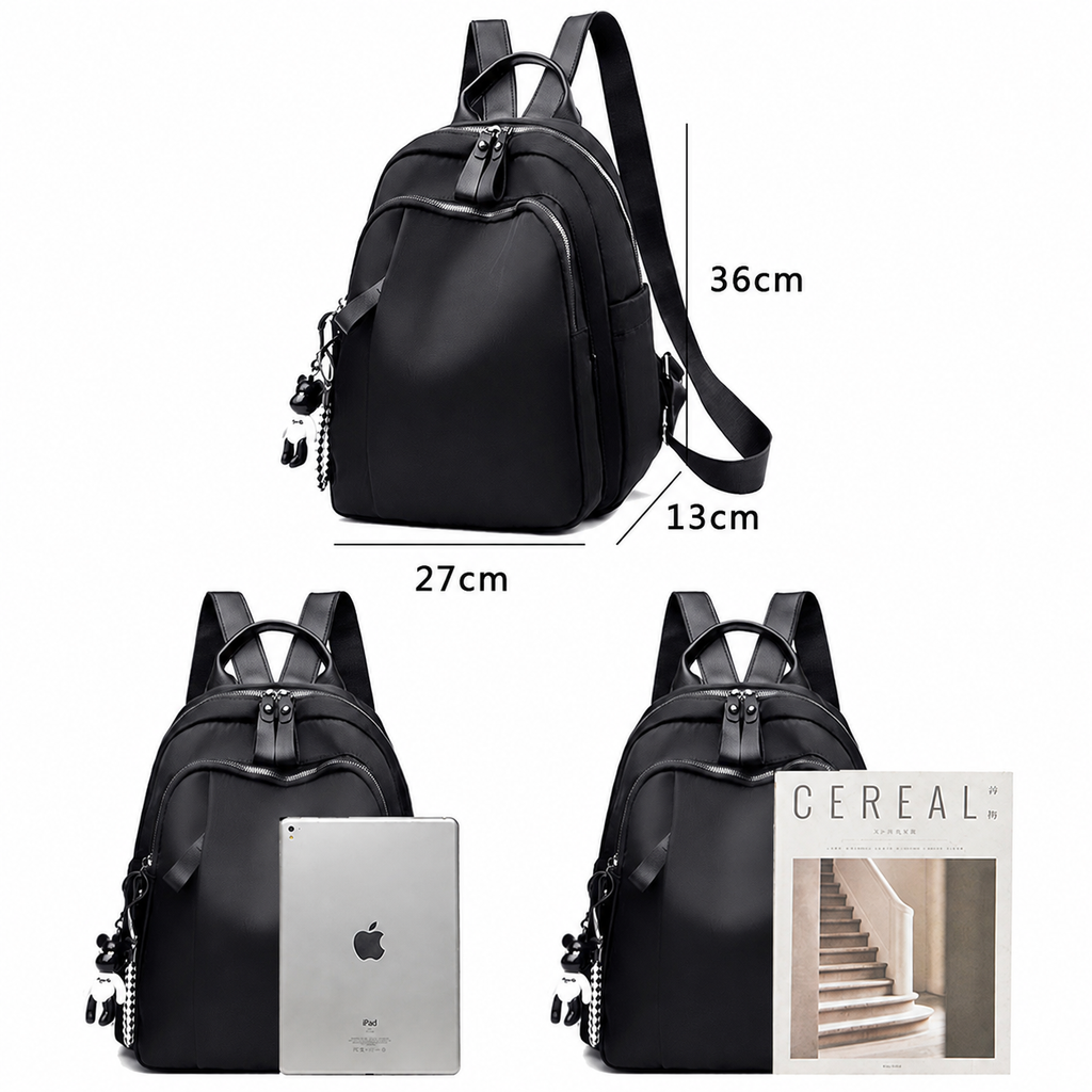 Black nylon backpack shown in three views on a white background, with dimension labels 36cm height, 27cm width, and 13cm depth, plus a tablet and a magazine placed in front to demonstrate capacity.
