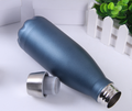 An insulated stainless-steel bottle in navy blue with silver cap.